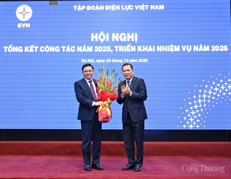 Chủ tịch HĐTV EVN Đặng Hoàng An thay mặt tập thể người lao động EVN tặng bó hoa tươi thắm đến Quyền Bộ trưởng Bộ Công Thương Lê Mạnh Hùng. Ảnh: Cấn Dũng