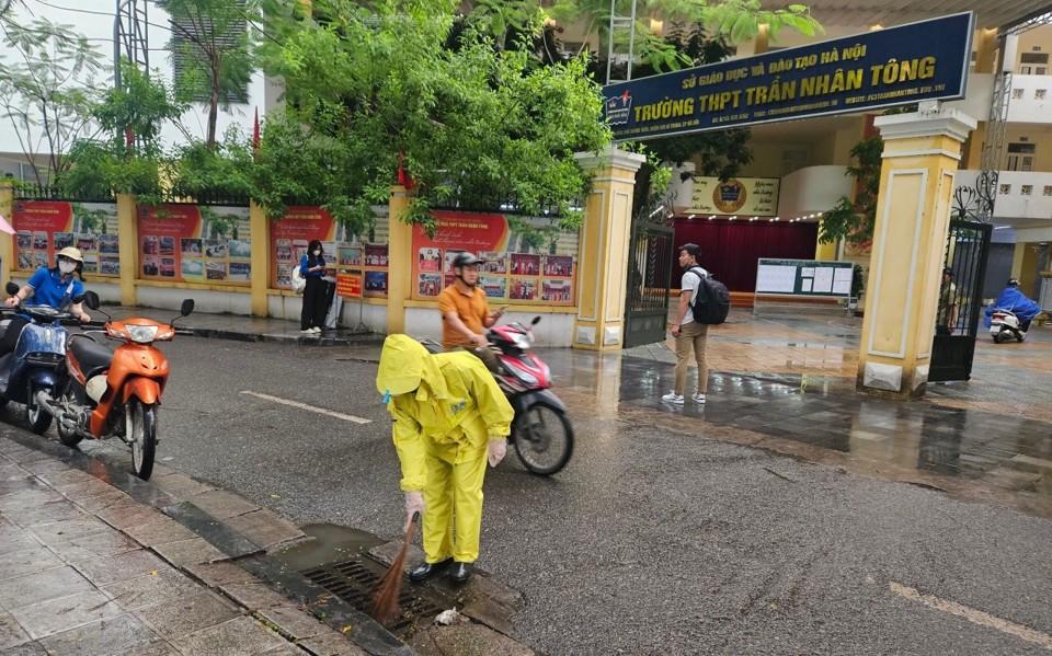 Ngay từ sáng sớm, công nhân thoát nước đã có mặt tại các điểm thi để làm nhiệm vụ. Trong ảnh, công nhân thoát nước làm nhiệm vụ tại điểm thi THPT Trần Nhân Tông.