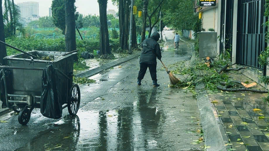 Công ty CP Môi trường Tây Đô thu dọn rác thải do cây xanh gẫy đổ gây ra trên đường Tô Ngọc Vân, quận Tây Hồ.