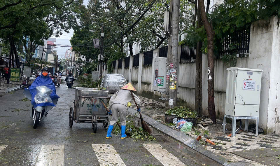 Tại quận Tây Hồ, Công ty CP Môi trường Tây Đô đang gấp rút thu dọn cành, lá do cây xanh gẫy đổ nhằm đảm bảo việc đi lại của Nhân dân.