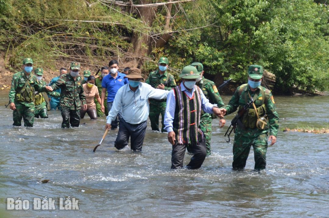Cụ Y Mốk (áo thổ cẩm) cùng người dân trong buôn
